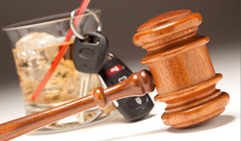 Gavel with a set of keys and an alcoholic drink